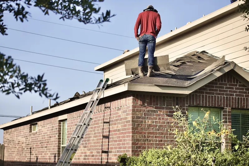 Professional roofer working on a residential roof in Purcellville